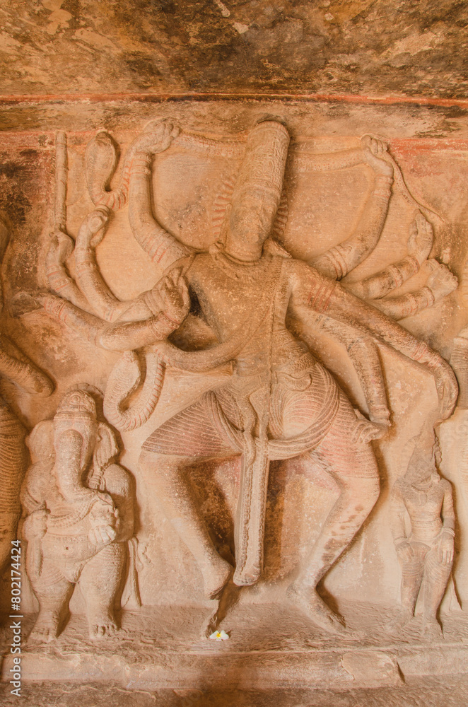 Fototapeta premium Sculpture or carving of dancing Shiva and Ganesha, Ravana padi Cave Temple Complex, Aihole, Badami, Karnataka, India.