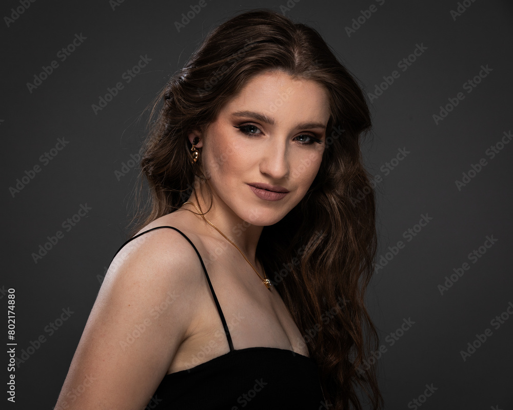 Fototapeta premium Beauty studio portrait of young beautiful woman against gray background.
