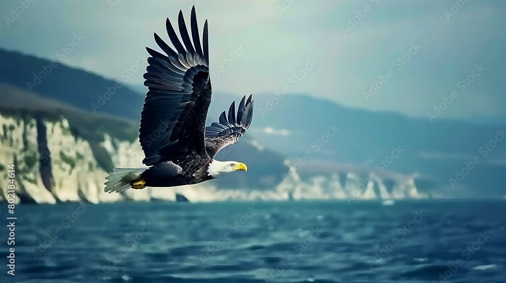 Fototapeta premium Eagle Soaring Majestically Over Rugged Mountain Peaks, Symbolizing Freedom, Power, and Natural Beauty in the Wilderness