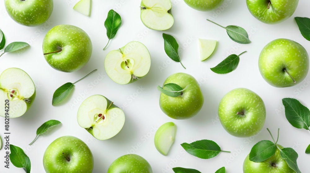 Flaying green apples, apple halves and slices and leaves on white background. Flaying green apples, apple halves and slices and leaves on white background.