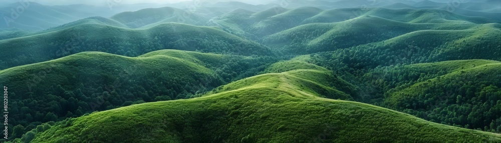 The photo shows a beautiful landscape of rolling green hills. The hills are covered in lush green grass and there are trees in the distance. The photo shows a beautiful landscape of rolling green hills. The hills are covered in lush green grass and there are trees in the distance.