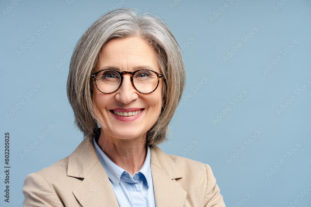 Fototapeta premium Smiling senior business woman, manager wearing eyeglasses looking at camera isolated