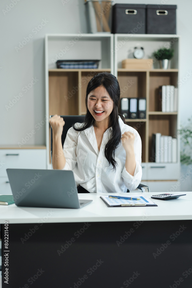 Excited woman work distant on computer talk on cellphone celebrate online win. Happy young female use laptop feel euphoric overjoyed triumph with good news over smartphone call. Excited woman work distant on computer talk on cellphone celebrate online win. Happy young female use laptop feel euphoric overjoyed triumph with good news over smartphone call.