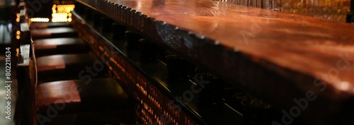 Wood bar counter with tall stools at restaurant lounge