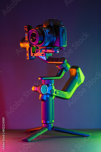 Close up on a modern gimbal for videomaking, background is black.