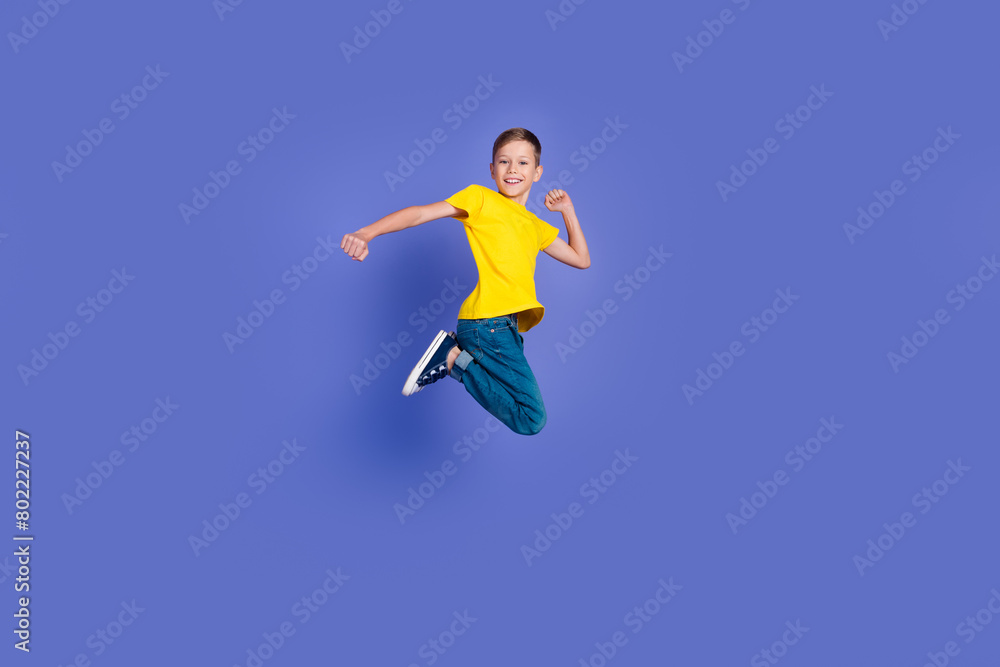 Full length photo of positive optimistic boy wear stylish clothes rejoice special seasonal sale isolated on violet color background Full length photo of positive optimistic boy wear stylish clothes rejoice special seasonal sale isolated on violet color background