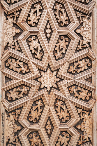 oriental Islamic pattern Uzbek traditional ornament on wooden carved door in Tashkent in Uzbekistan close-up photo