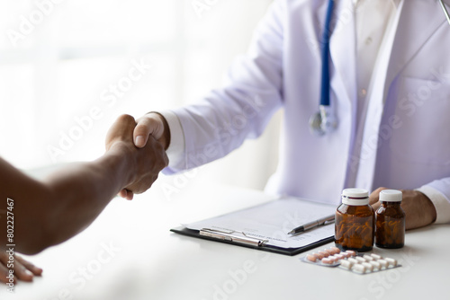 Patient and doctor discussing in hospital examination room.