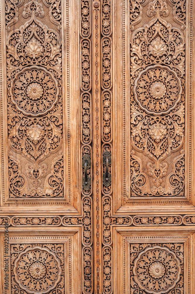 carved wooden door with oriental pattern Uzbek ornament in the Museum of Victims of Political Repression in Tashkent close-up