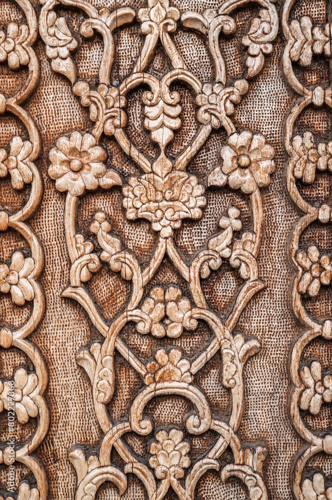 flower pattern Uzbek traditional ornament on wooden carved door in Tashkent in Uzbekistan close-up