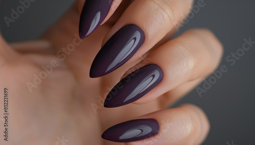 woman's hand with long almond shaped nails in future dusk color photo