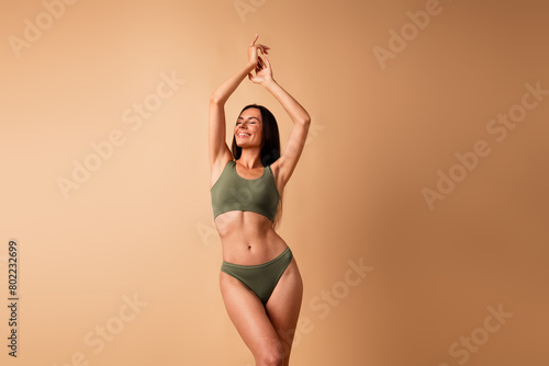 Photo of attractive cheerful girl raise hands up posing enjoy body care treatment isolated pastel color background photo