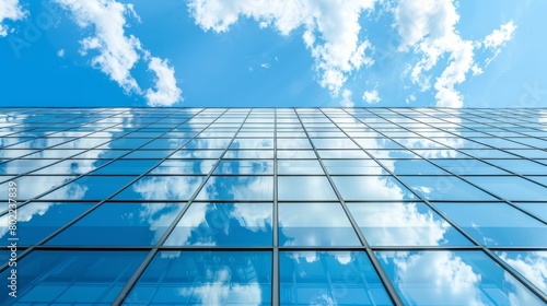Fragment of the mirror wall of the building against the blue sky. office building covered with glass. Place for an inscription  advertising. Panorama