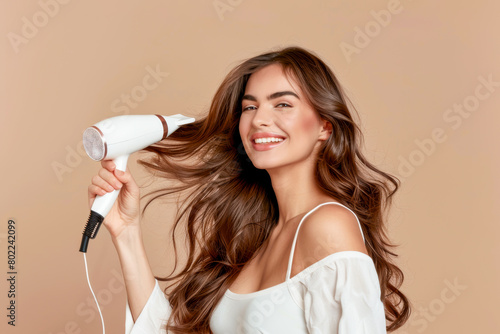 Happy Woman Styling Hair with Blow Dryer