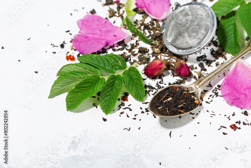 ingredients for making tea with wild rose on a white background
