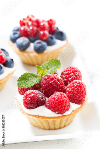 mini cakes with cream and fresh berries, vertical © cook_inspire