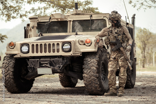 United States Army in camouflage uniforms operation in the forest.with armored vehicle, soldiers training  in a military operation
