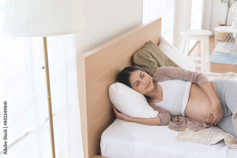 Pregnant woman sleeping on the bed, pregnancy and expectation concept Pregnant woman sleeping on the bed, pregnancy and expectation concept