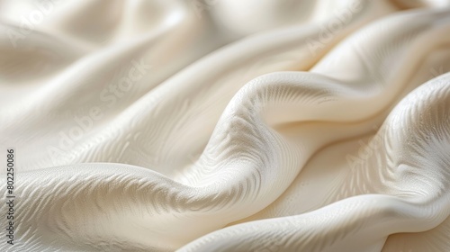 Close-up of a soft, cream-colored fabric with a wavy texture.
