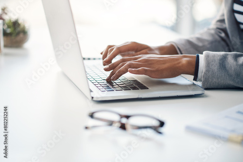 Office, typing and hands of woman at laptop for research, business review or online report at agency. Budget, planning and consultant at desk with computer, networking and financial risk management photo