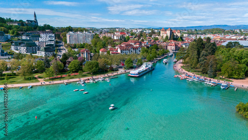 Aerial view of Annecy and the lake, homes and green spaces, boats for navigation and pedestrian areas. Haute-Savoie. Pearl of the French Alps. France