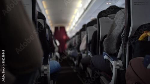 Flight in the plane. Passengers sitting in chairs on the plane. Footage can be used for your video.