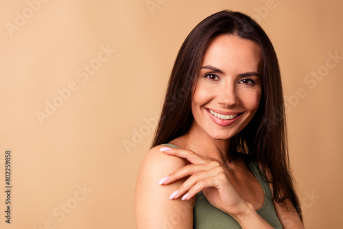 Portrait of joyful lady touch shoulder arms enjoy soft fresh skin after applying balm isolated pastel color background