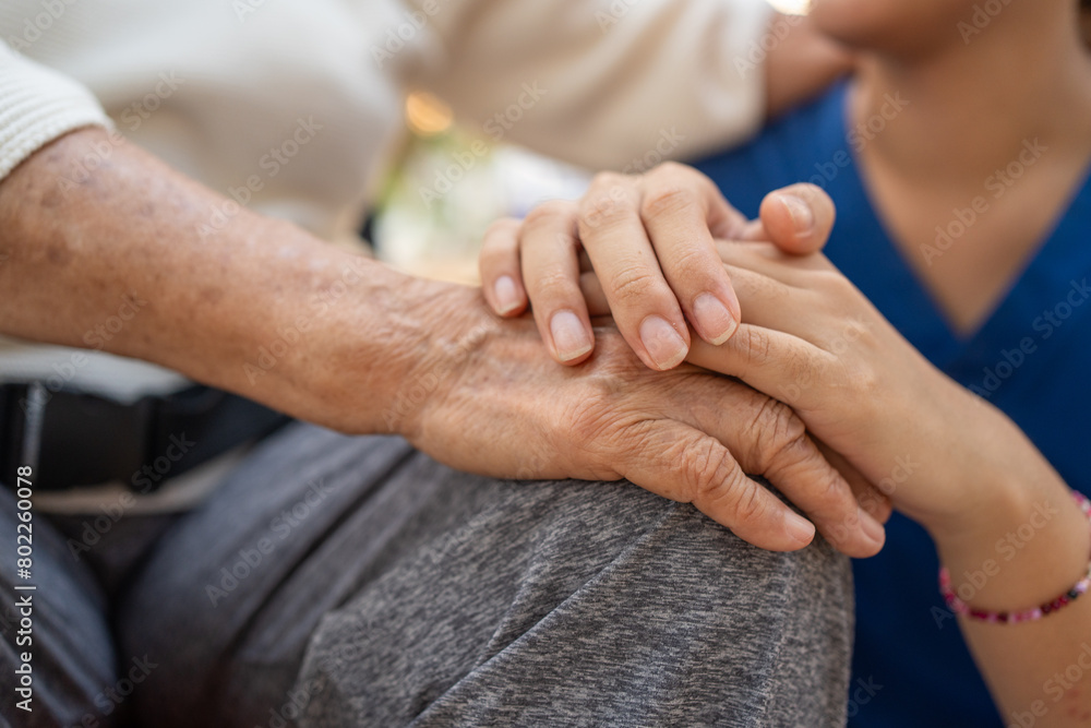 Close up of the hand of a nurse and an elderly woman. Caregiver and patient, Consolation, encouragement, concern, take care, careful. Health insurance. Close up of the hand of a nurse and an elderly woman. Caregiver and patient, Consolation, encouragement, concern, take care, careful. Health insurance.