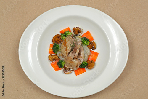 Grilled Quail Game Bird With Mushrooms and Vegetables Dinner Served in Oval Plate photo