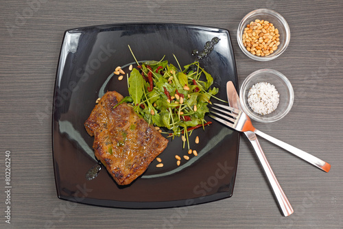 Grilled Steak and Arugula Salad With Pignoli Nuts Served at Black Plate Tabletop photo