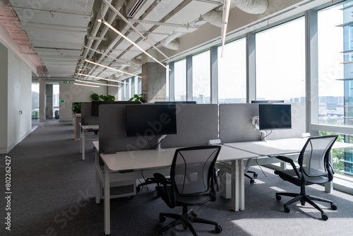 Interior of modern empty office building.Open ceiling design.Equipped with automatic lifting table and LCD screen.