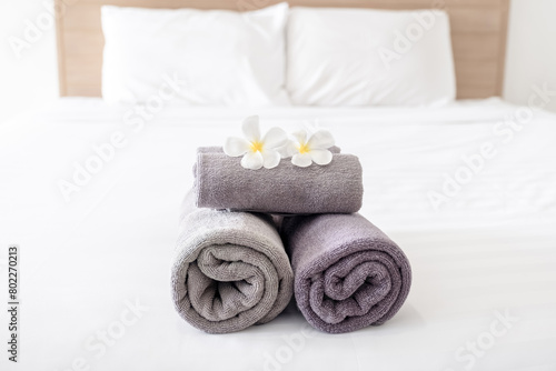 Plumeria and towels on the bed in the luxury hotel room ready for tourist travel