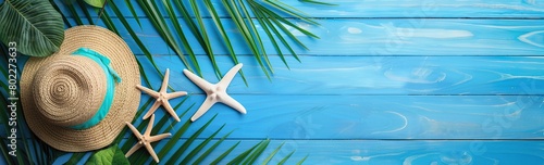 Summer beach background with shells, starfish and straw hats on wooden floor. photo