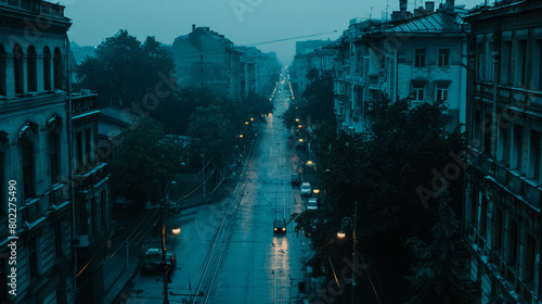 Rainy cityscape with glowing street lights at dusk