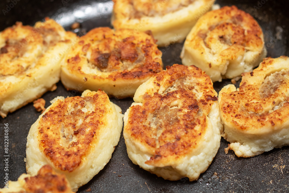 Meat sizzling in a frying pan for a delicious dish Meat sizzling in a frying pan for a delicious dish