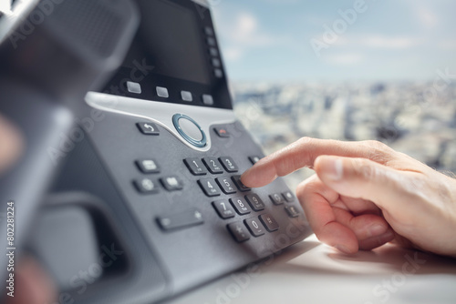 Dialing a landline telephone in the office © Brian Jackson