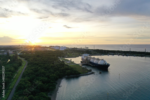 Aerial view of a gas tanker or LNG carrier docked at a gas industrial factory area