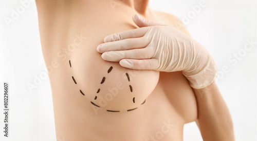 Female hand in gloves holding breast closeup on doctor mammology clinic reception. Mammary glands test biopsy implant silicone insert tumor human concept