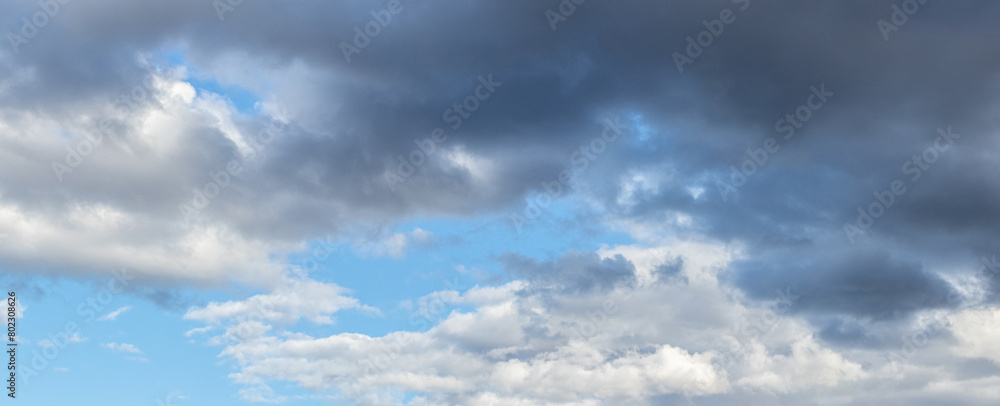 Dark gray and white clouds in the blue sky Dark gray and white clouds in the blue sky