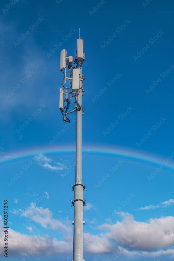 Signal tower or Mobile phone tower against the sky with a rainbow. Signal tower or Mobile phone tower against the sky with a rainbow.