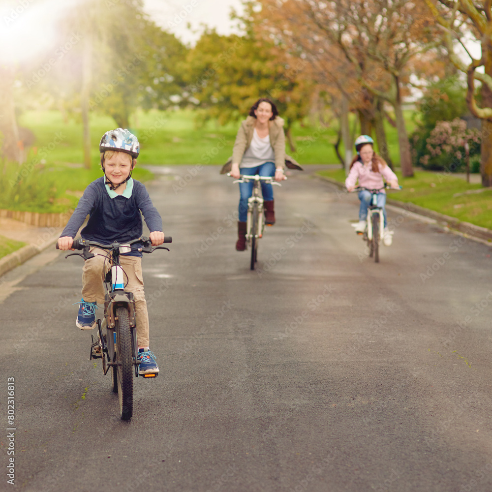 Boy, family and bicycle for fun outside, road and mother with sister in nature for bonding and childhood development. Growth, helmet and safety, riding and children in neighbourhood with parent Boy, family and bicycle for fun outside, road and mother with sister in nature for bonding and childhood development. Growth, helmet and safety, riding and children in neighbourhood with parent
