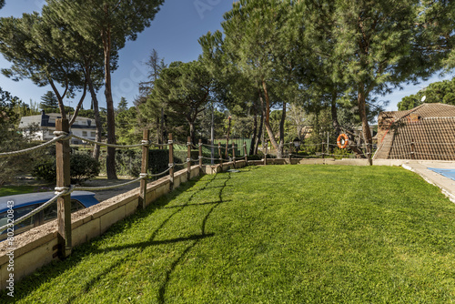Wallpaper Mural pool garden with natural grass floor and wooden railing and ropes at the edge Torontodigital.ca