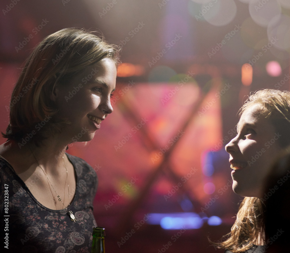 Women, friends and talking in nightclub for excited conversation with gossip, bokeh lights and bottle. Girls, speaking together and happy at party for birthday with night out, music and social life Women, friends and talking in nightclub for excited conversation with gossip, bokeh lights and bottle. Girls, speaking together and happy at party for birthday with night out, music and social life