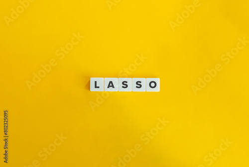 LASSO (least absolute shrinkage and selection operator). Text and Acronym on Block Letter Tiles on Yellow Background. Minimalist Aesthetics. photo
