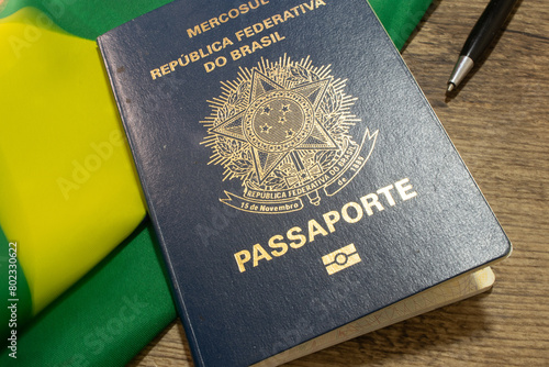 LAURO DE FREITAS, BRAZIL - April 26, 2024 : Brazilian passport next to the Brazilian flag photo