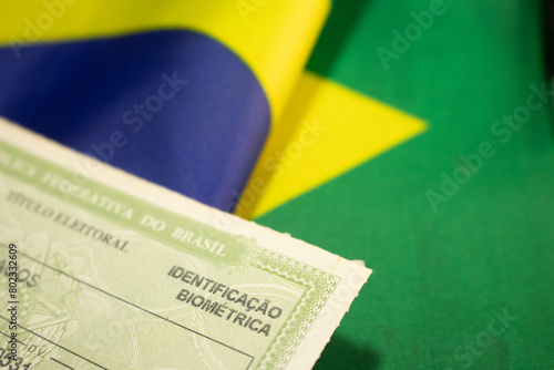 LAURO DE FREITAS, BRAZIL - April 26, 2024 : Brazilian voter registration card next to the Brazilian flag