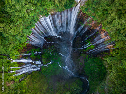 Aerial top view from above of Tumpak Sewu ,also known as Coban Sewu, 120m high waterfall in Malang regency, East Java, Indonesia photo