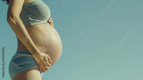 Closeup view of swelling belly of a pregnant woman. photo