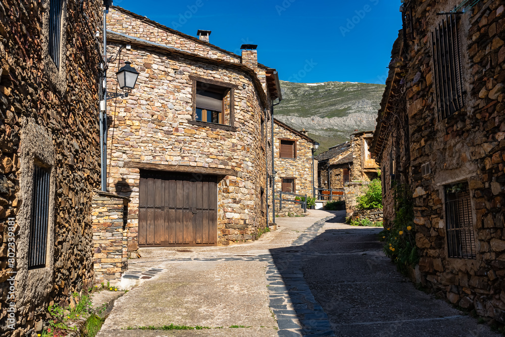 Narrow picturesque alley with stone houses next to the mountains of central Spain. Narrow picturesque alley with stone houses next to the mountains of central Spain.