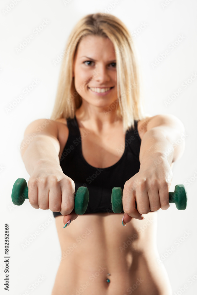Beautiful woman athlete holding hand weights Beautiful woman athlete holding hand weights